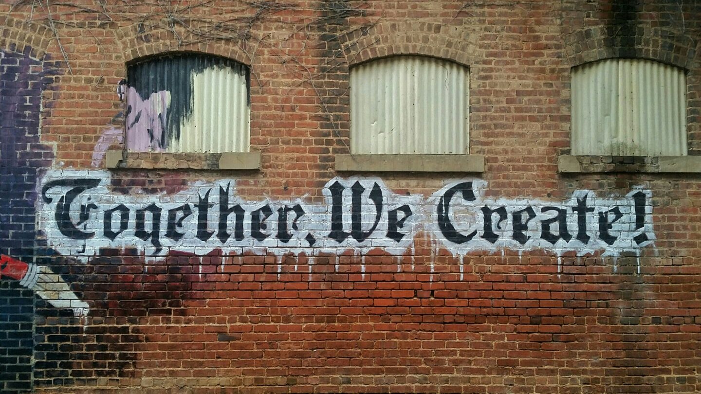 White and black 'Together We Create' wall decor 