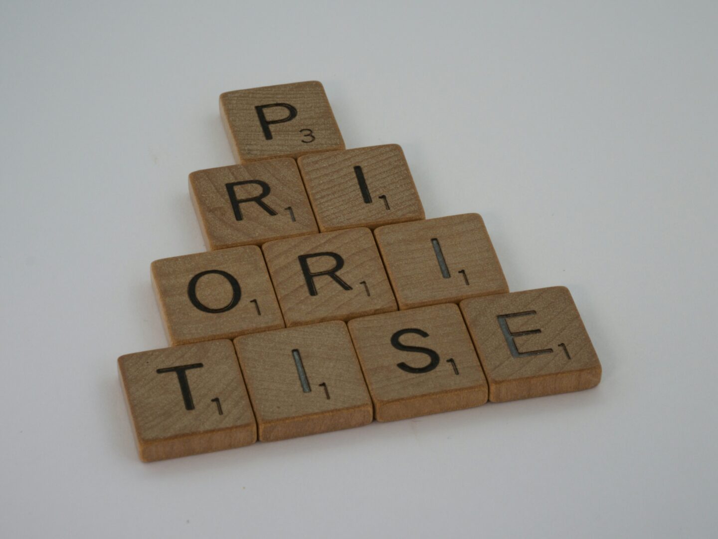 a scrabbled wooden block spelling the word 'prioritise' 
