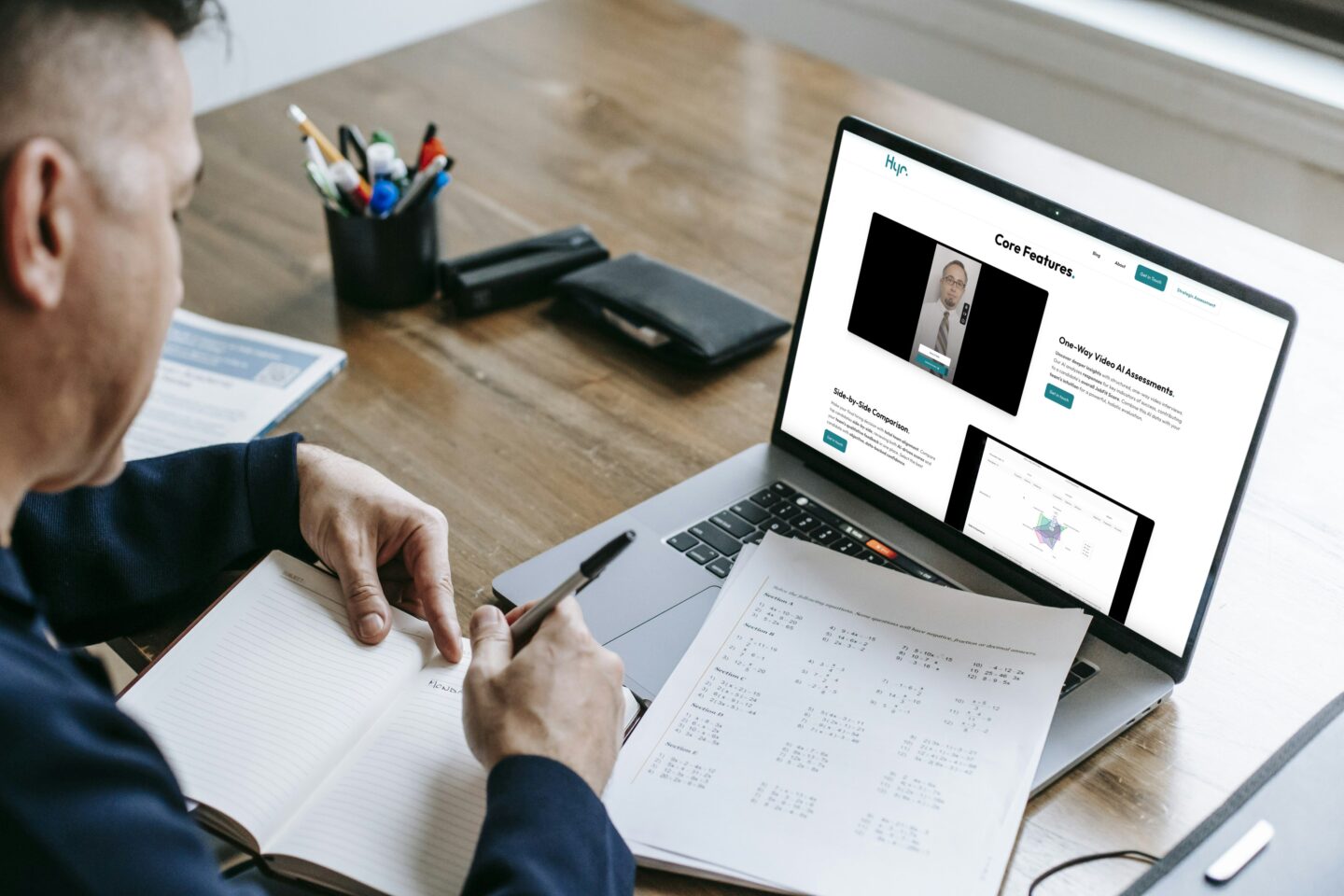Image showing a man working on his desktop with Hyr web app on the laptop screen.