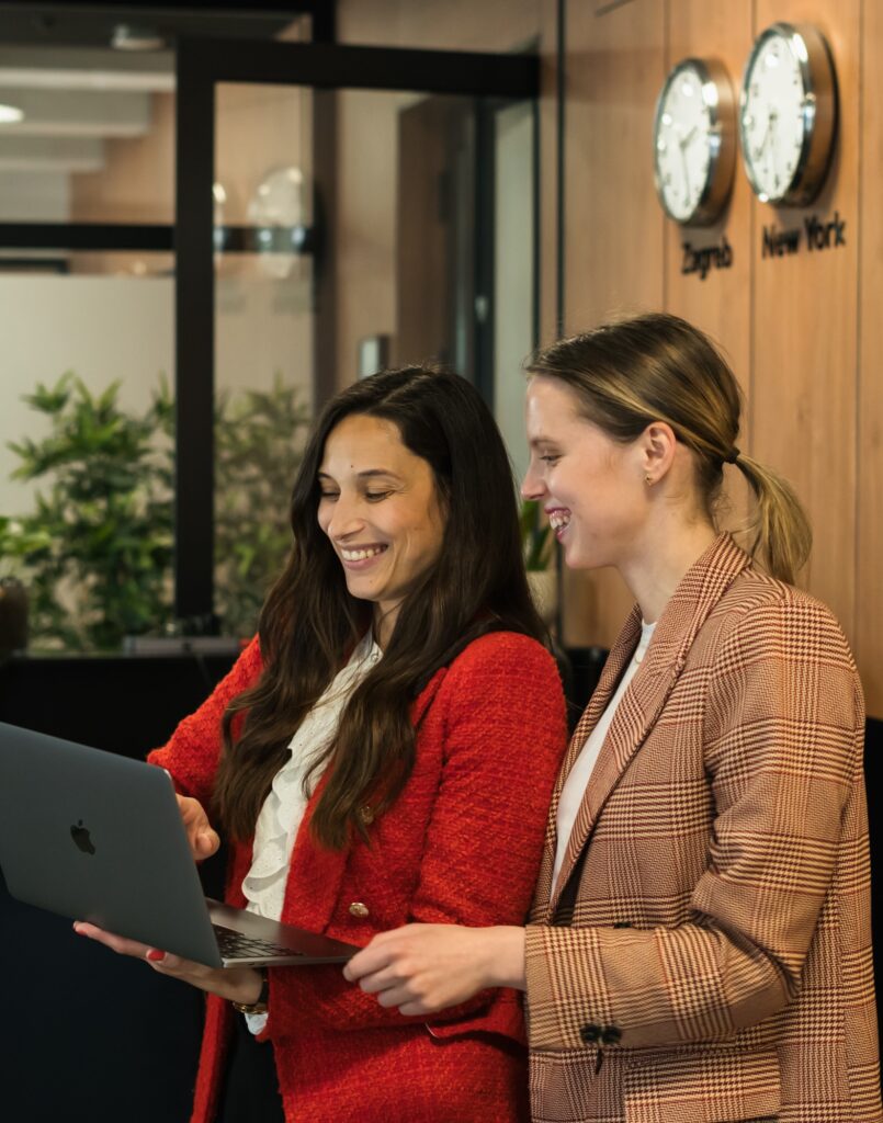 Q team members collaborating on a laptop in the office.