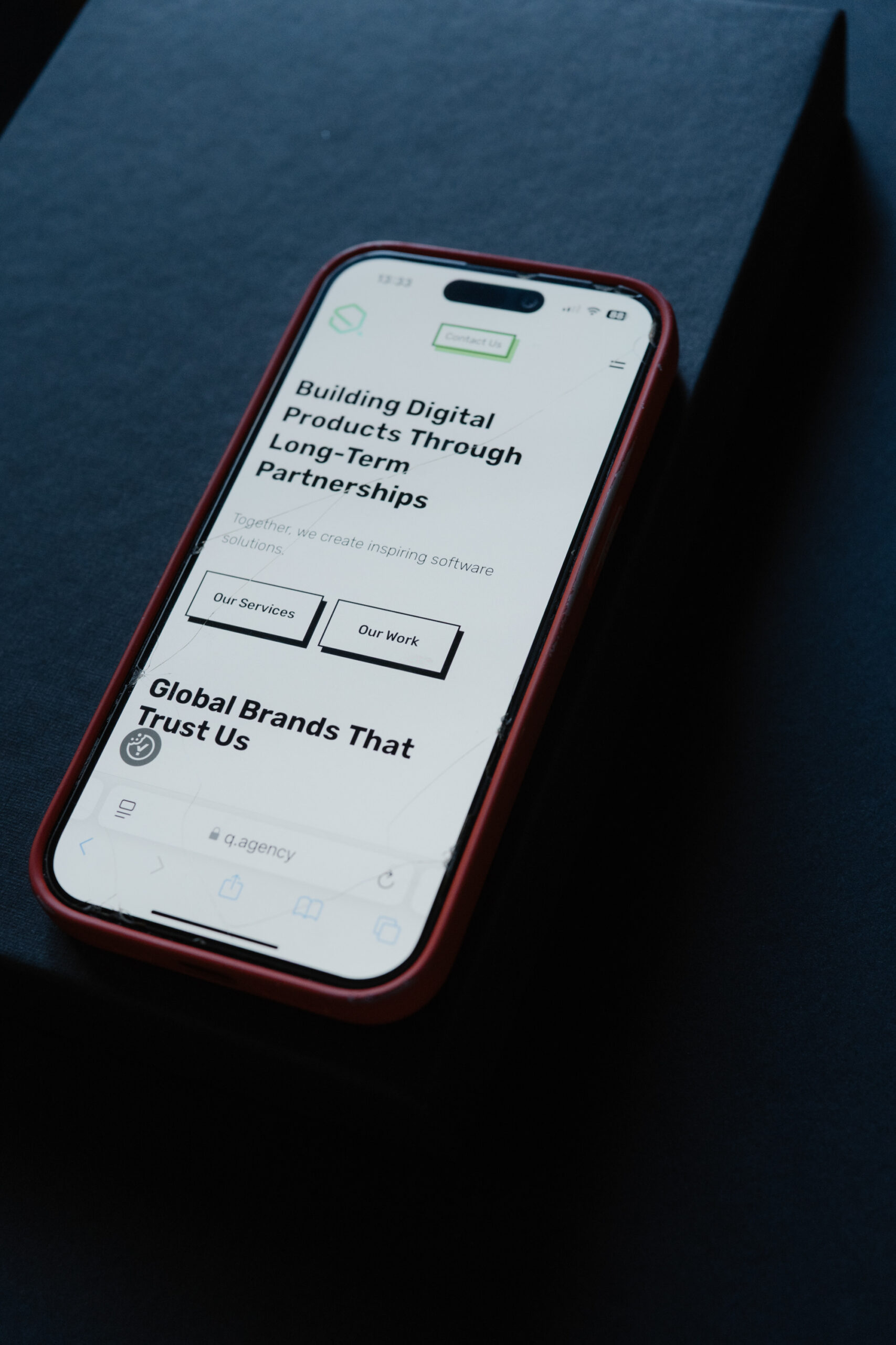 Image showing a phone screen saying 'Building Digital Products Through Long-Term Partnerships'.